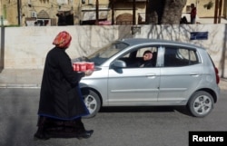 Thaera Arabiyat menawarkan sup tradisional kepada seorang pengemudi di Salt, Yordania 21 Januari 2023. (REUTERS/Jehad Shelbak)