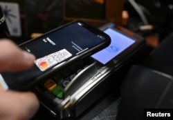 Pelanggan melakukan pembayaran dengan dompet digital kartu bank Tinkoff di sebuah kafe di Omsk, Rusia, 1 Maret 2022. (REUTERS/Alexey Malgavko)